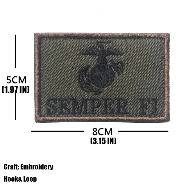 A dark olive embroidered patch featuring a silhouette of a trident and the text SEMPER FI