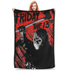 A woman holds up a black fleece throw blanket featuring a distressed design with the text Friday the 13th and a skull.