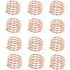 A set of elegant rose gold metal napkin rings for table decoration.