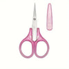 A pair of pink precision craft scissors with a protective cap shown against a white background.