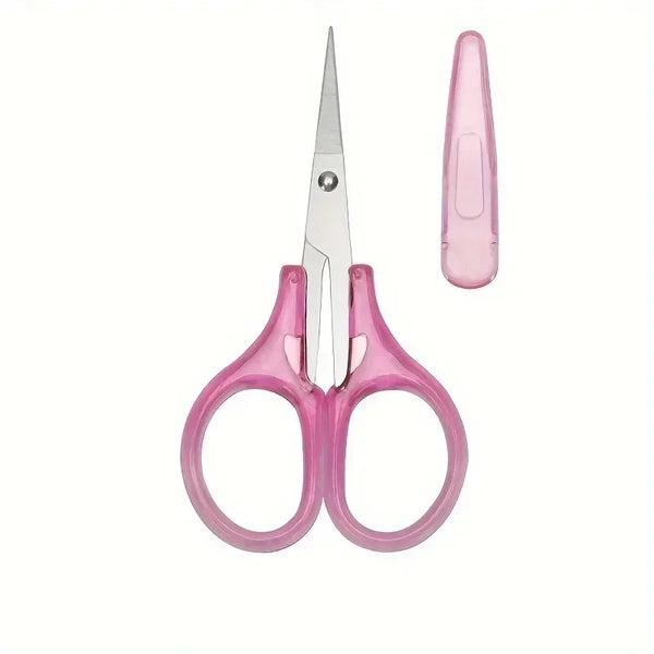 A pair of pink precision craft scissors with a protective cap shown against a white background.