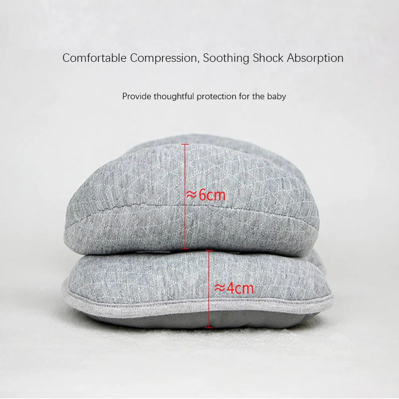 Gray compression pillow demonstrating 6cm and 4cm thickness for baby head and neck support
