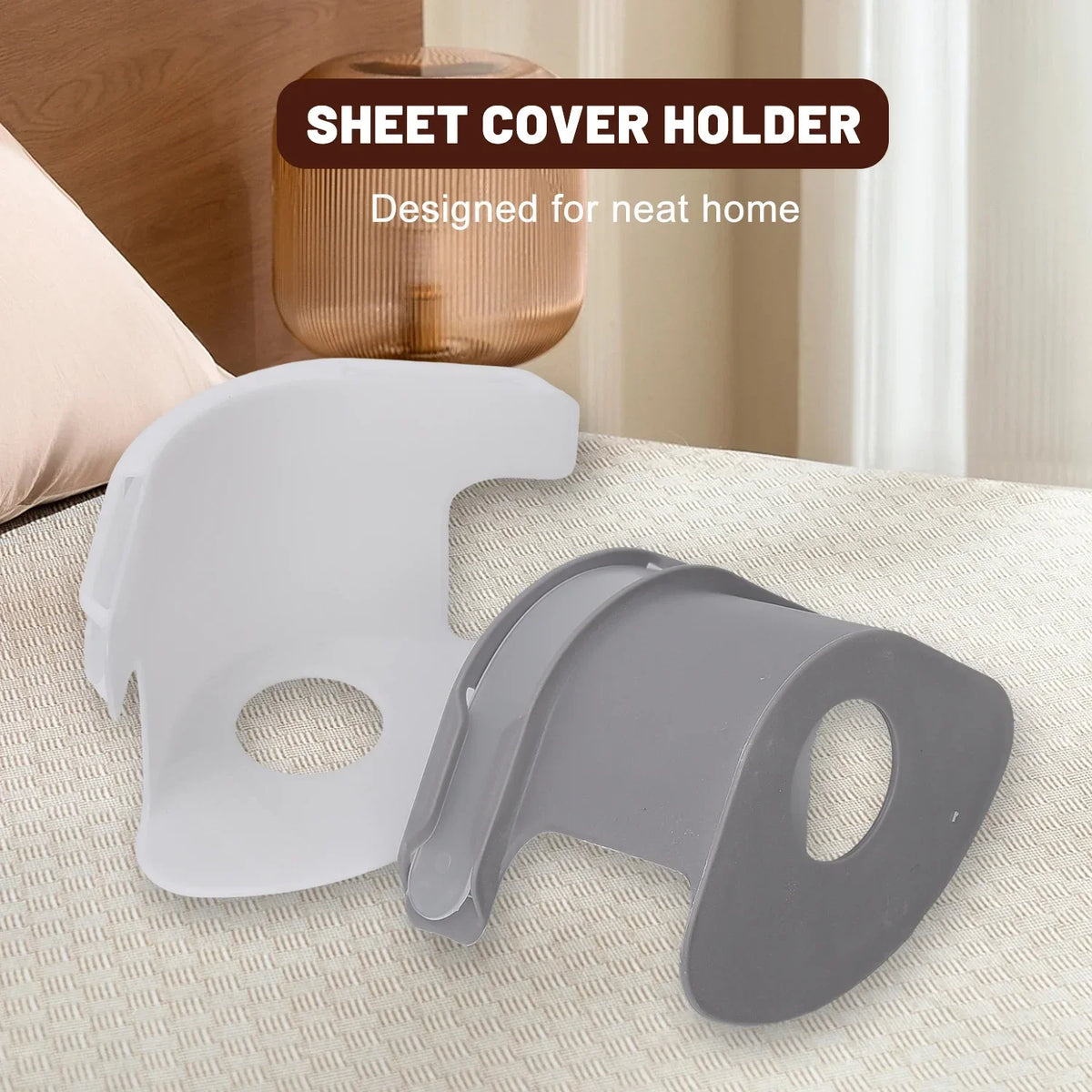 A white sheet cover holder clip and a gray clip are shown on a light-colored surface.