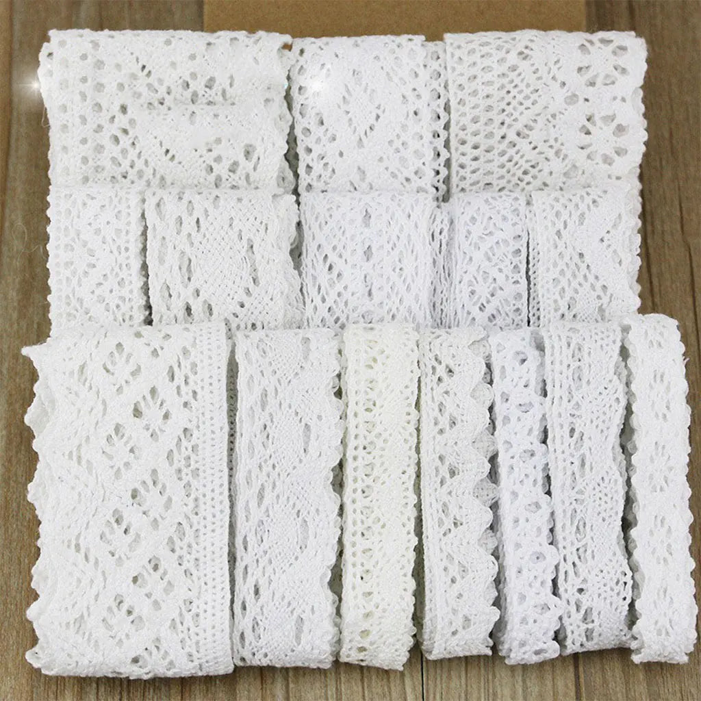 Roll of white cotton embroidered lace trim in various widths and patterns