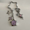 Silver star pocket watch keychain featuring a butterfly charm and a pink gemstone detail.