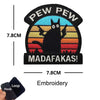 Black embroidered patch featuring a cat silhouette against a sunset background with text reading Pew Pew and MADAFAKAS!