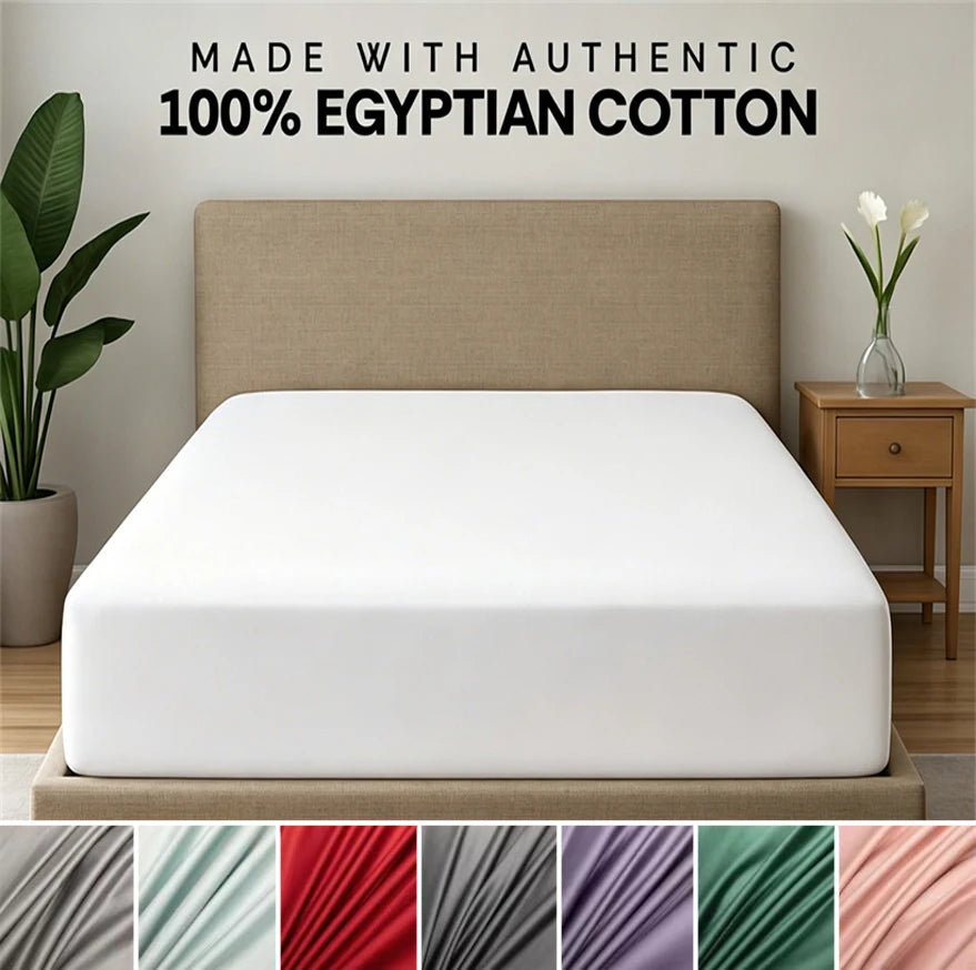 White fitted sheet and pillow set displayed on a bed with a neutral headboard.