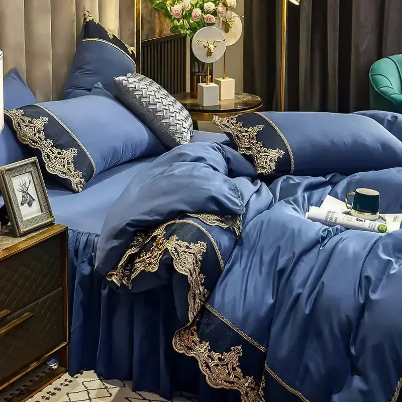 A luxurious blue bed skirt set featuring elegant lace edge detailing and pillows in a bedroom setting.