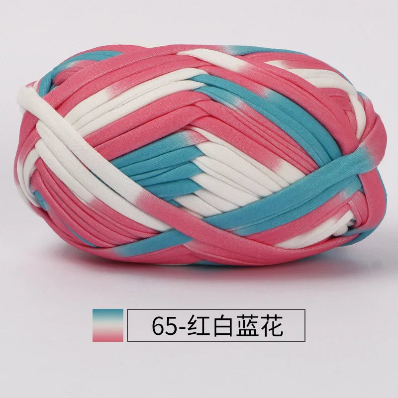 A ball of hand-dyed fabric strip yarn featuring pink, white, and blue stripes.