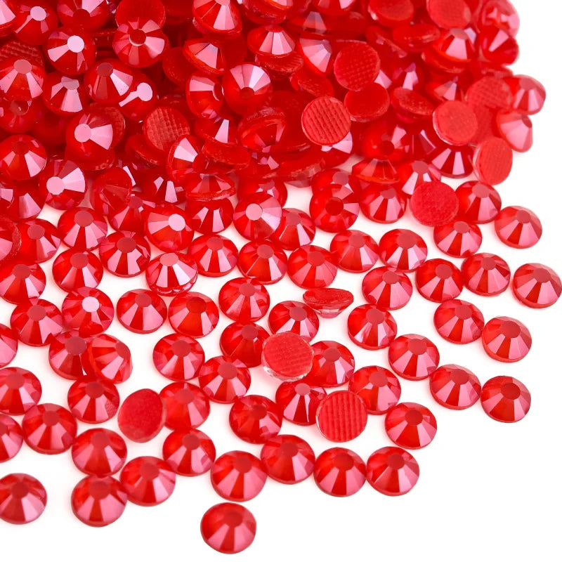 A pile of bright red flatback glass rhinestones and round glass decorations.