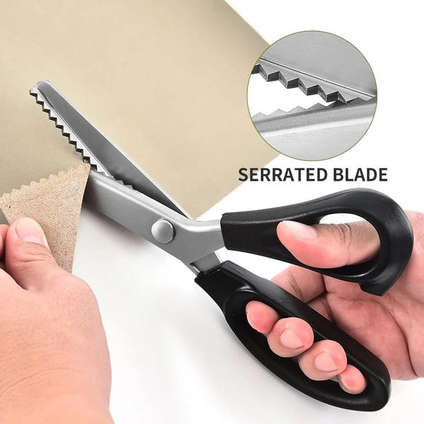 A pair of professional stainless steel tailor's shears with a serrated blade being held by a hand.
