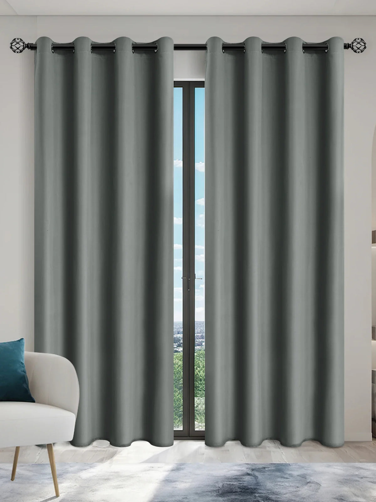Gray blackout window curtains hanging in a doorway with a view outside