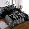 A king size duvet cover set featuring a grey and black design displayed on a bed.