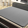 A gray heat-resistant silicone stove top cover mat placed inside an oven or appliance.