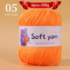 A ball of bright orange soft yarn labeled as 6 pieces equal to 300 grams for handmade knitting thread.