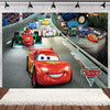 A Disney Pixar Cars themed backdrop featuring various race cars and a racetrack scene.