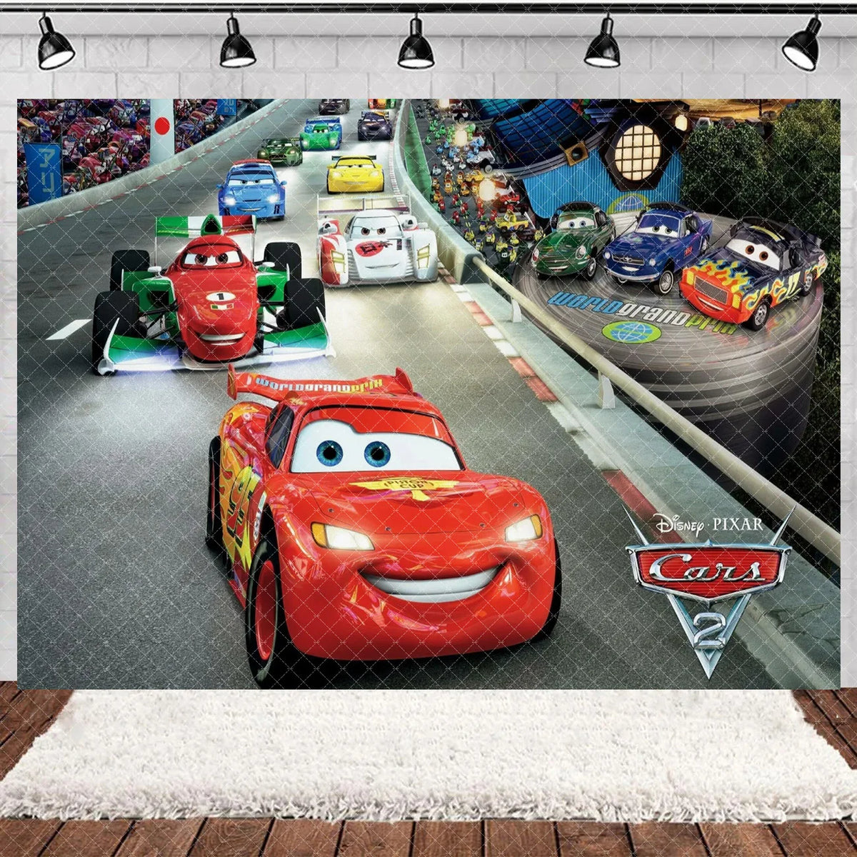 A Disney Pixar Cars themed backdrop featuring various race cars and a racetrack scene.