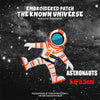 Embroidered patch featuring an astronaut figure in an orange and white suit against a starry background.
