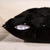 Black velvet throw pillow cover with a textured, fuzzy top and a smooth base.