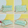 A light green PU leather coin purse with a white and orange daisy floral pattern shown in multiple angles.