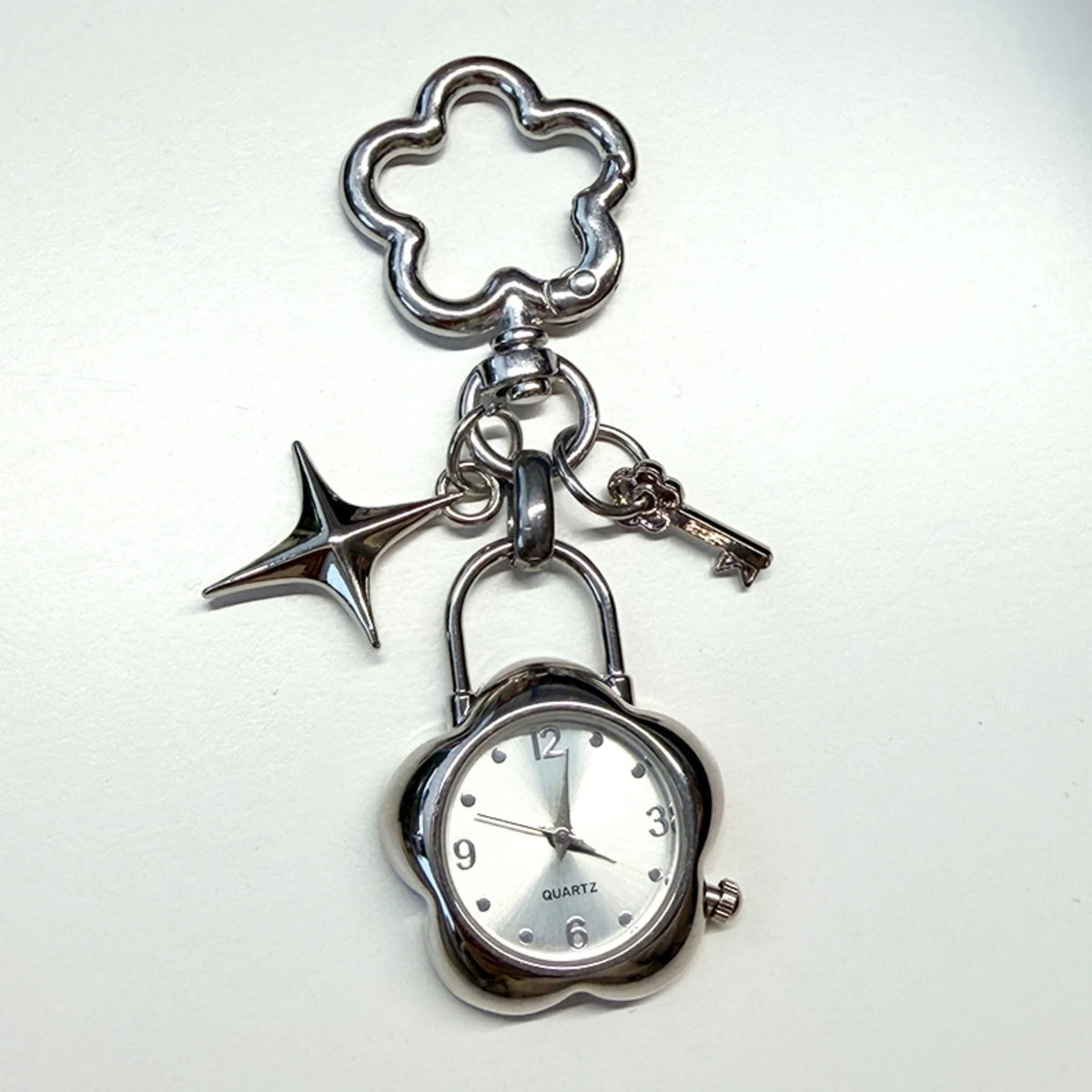 Silver star-shaped pocket watch keychain with a chain and adjustable clock face