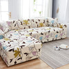 A beige sofa protector cover featuring a floral and leaf print on a light-colored fabric.