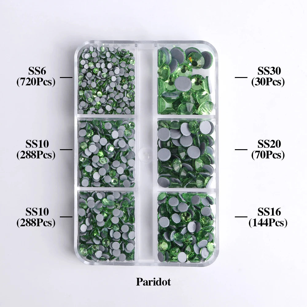 A plastic tray containing various sizes of green glass rhinestones, including SS6, SS10, SS20, SS30, and SS16.