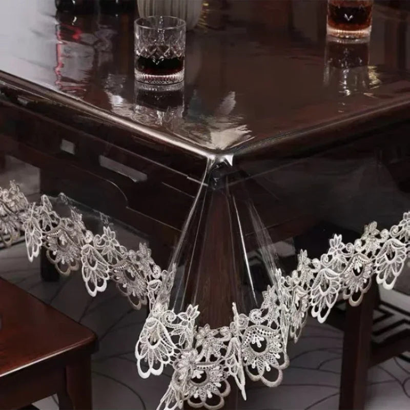 Lace embroidered PVC tablecloth with waterproof finish draped over a dark wooden table.