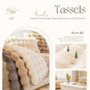 A close-up of a fluffy, light beige rabbit plush massage sense design cushion cover on a sofa.