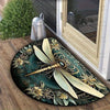A decorative doormat featuring a golden dragonfly with intricate floral designs on a dark green background.