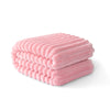 A stack of pink striped flannel throw blankets folded neatly on a white surface.