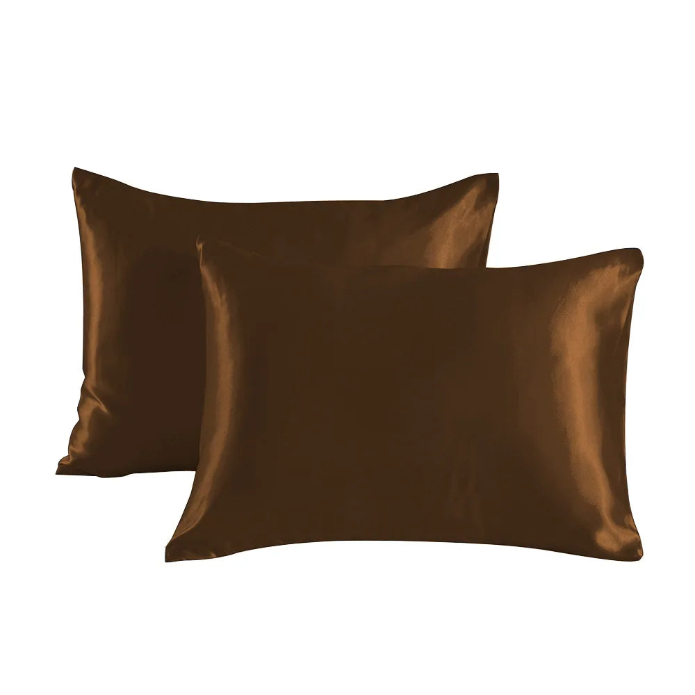 Two smooth brown satin pillowcases lying flat.