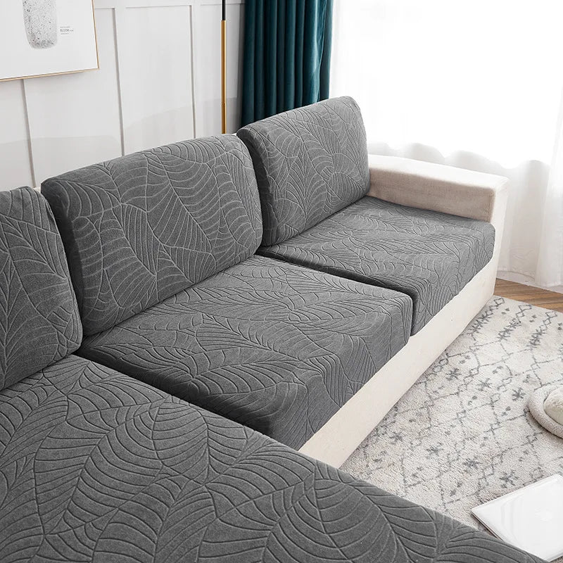 Gray splashproof jacquard sofa cushion covers on a modern sofa in a bright room.