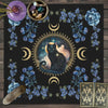 A dark mat featuring a celestial cat, floral elements, and tarot cards.