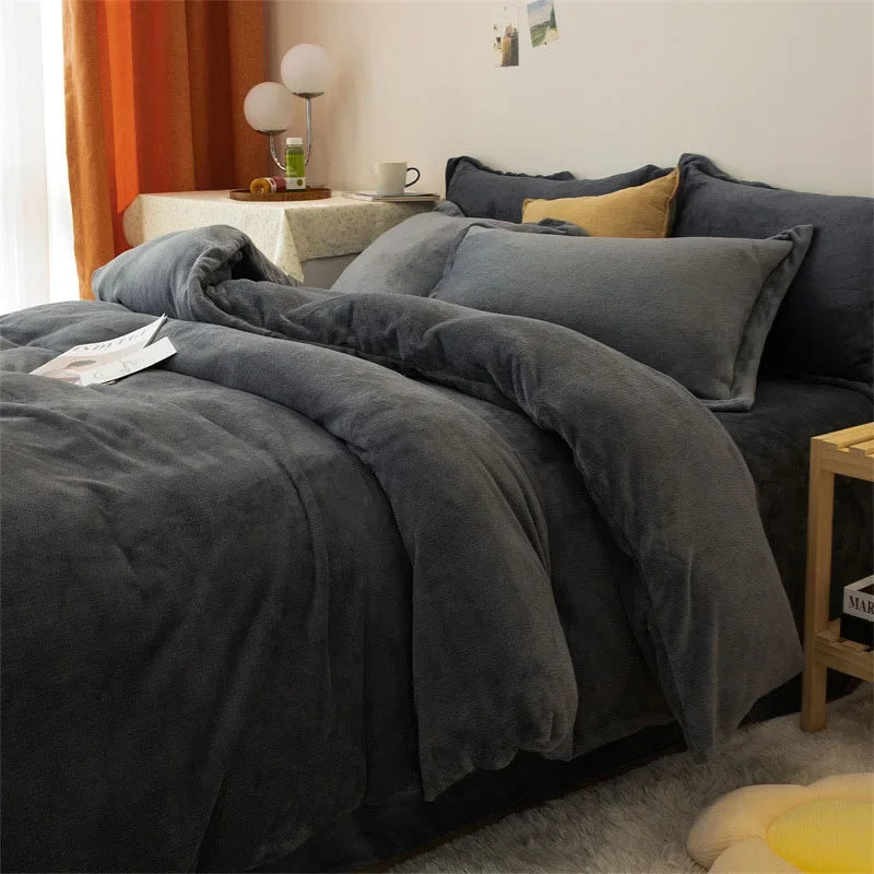 A dark gray luxurious flannel duvet cover set on a bed with light yellow accents and orange curtains.