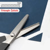 Stainless steel sewing scissors with a zig zag edge shown next to a measuring tool.
