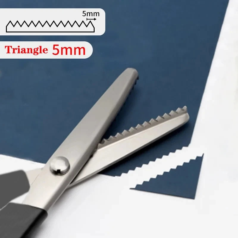 Stainless steel sewing scissors with a zig zag edge shown next to a measuring tool.