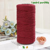 A roll of medium-thick, hand-woven cotton yarn in a deep reddish-pink color for crafting.