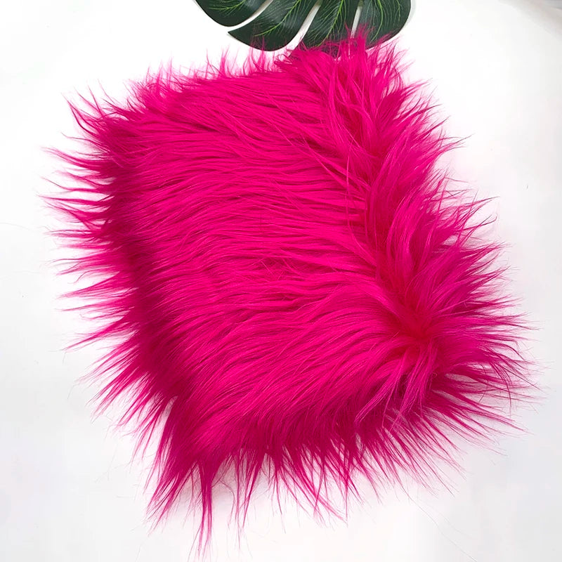 Vibrant magenta faux fur plush fabric used for sewing and crafting.