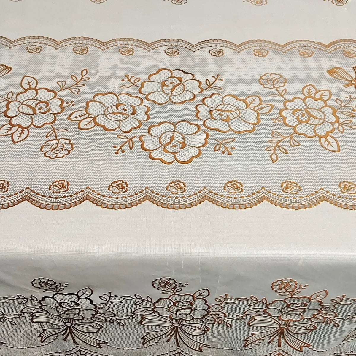White dining table cloth with delicate brown floral embroidery and lace trim.