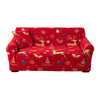 A red festive sofa cover featuring reindeer, Christmas trees, and holiday patterns.
