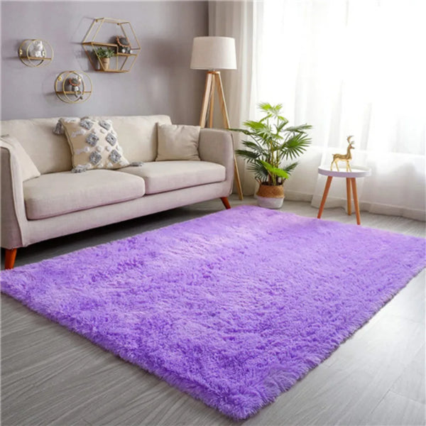 A vibrant purple plush anti-slip area rug placed on a gray floor in a bright living room setting.
