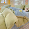 A cozy milk velvet duvet cover set featuring soft olive green and blue tones.