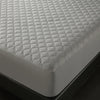 A close-up view of a gray quilted mattress protector placed on a dark surface.