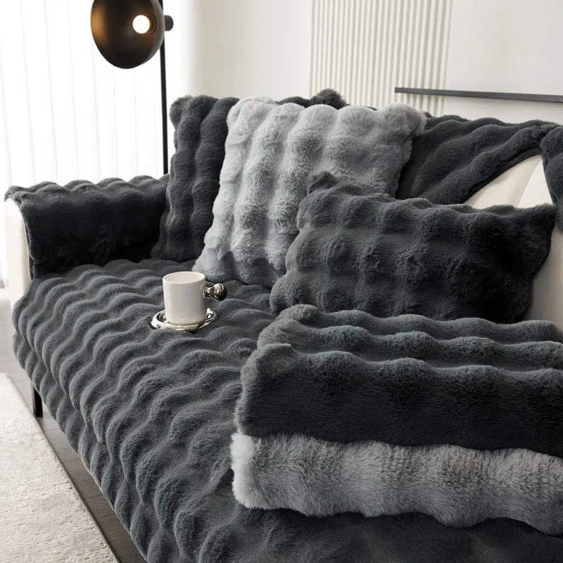 A dark gray plush velvet sofa cover with a textured, wavy pattern displayed on a sofa.