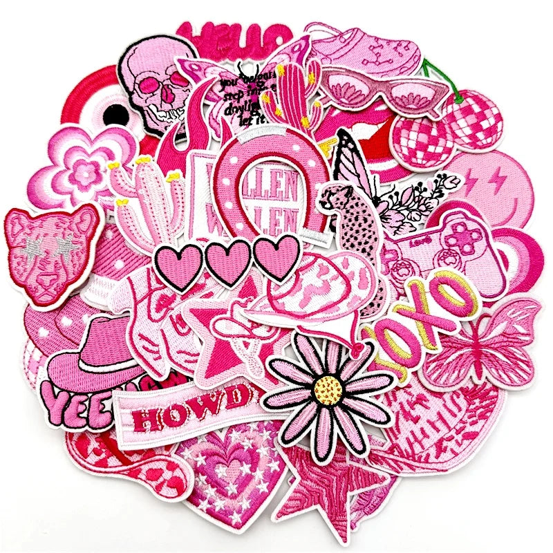 A collection of pink embroidered applique patches featuring various floral, skull, and decorative elements for DIY projects.