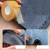A roll of yellow no-sew hem tape is shown next to a piece of denim fabric, demonstrating its use for quick folds and repairs.