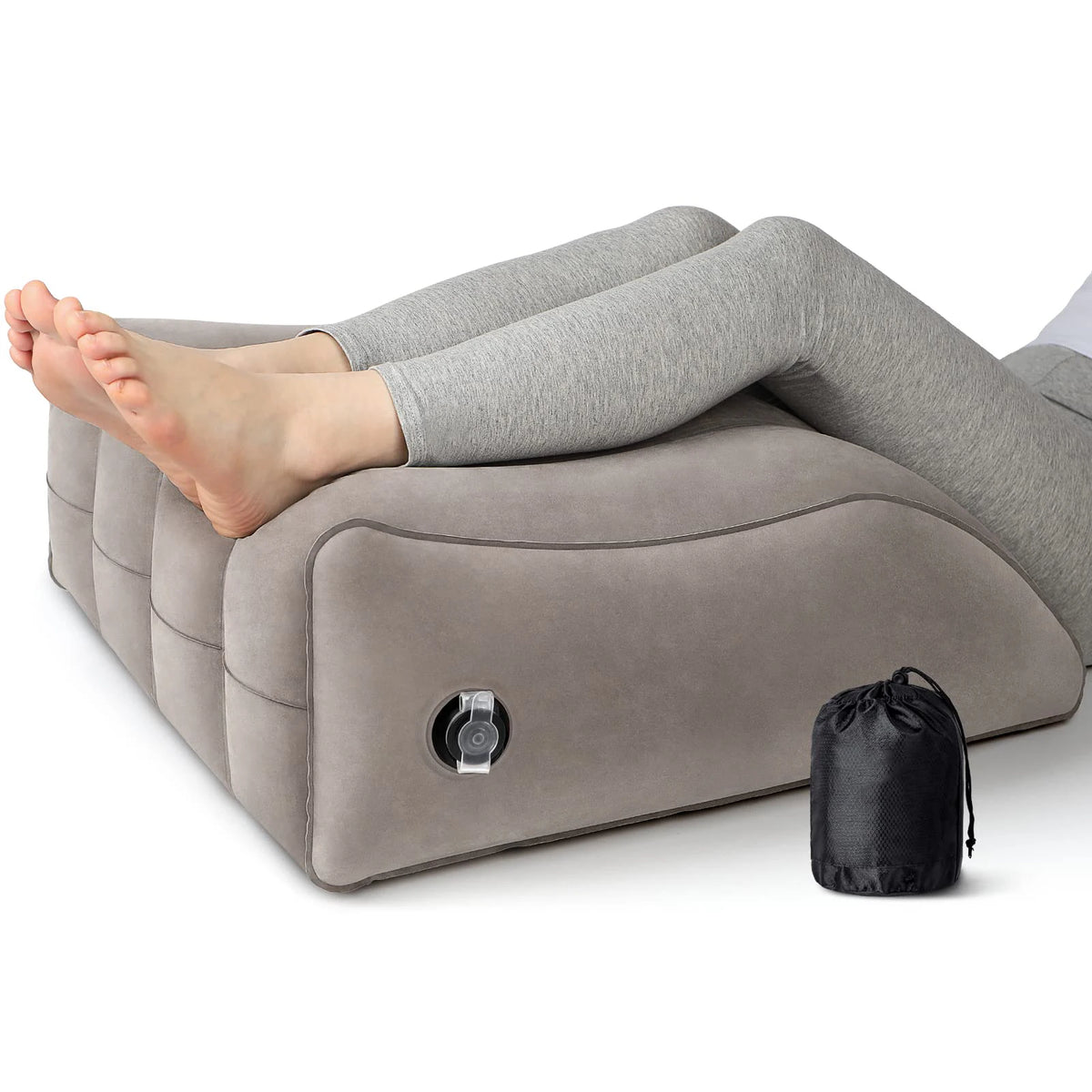 A gray inflatable leg elevation wedge pillow is shown supporting a person's legs for pain relief.