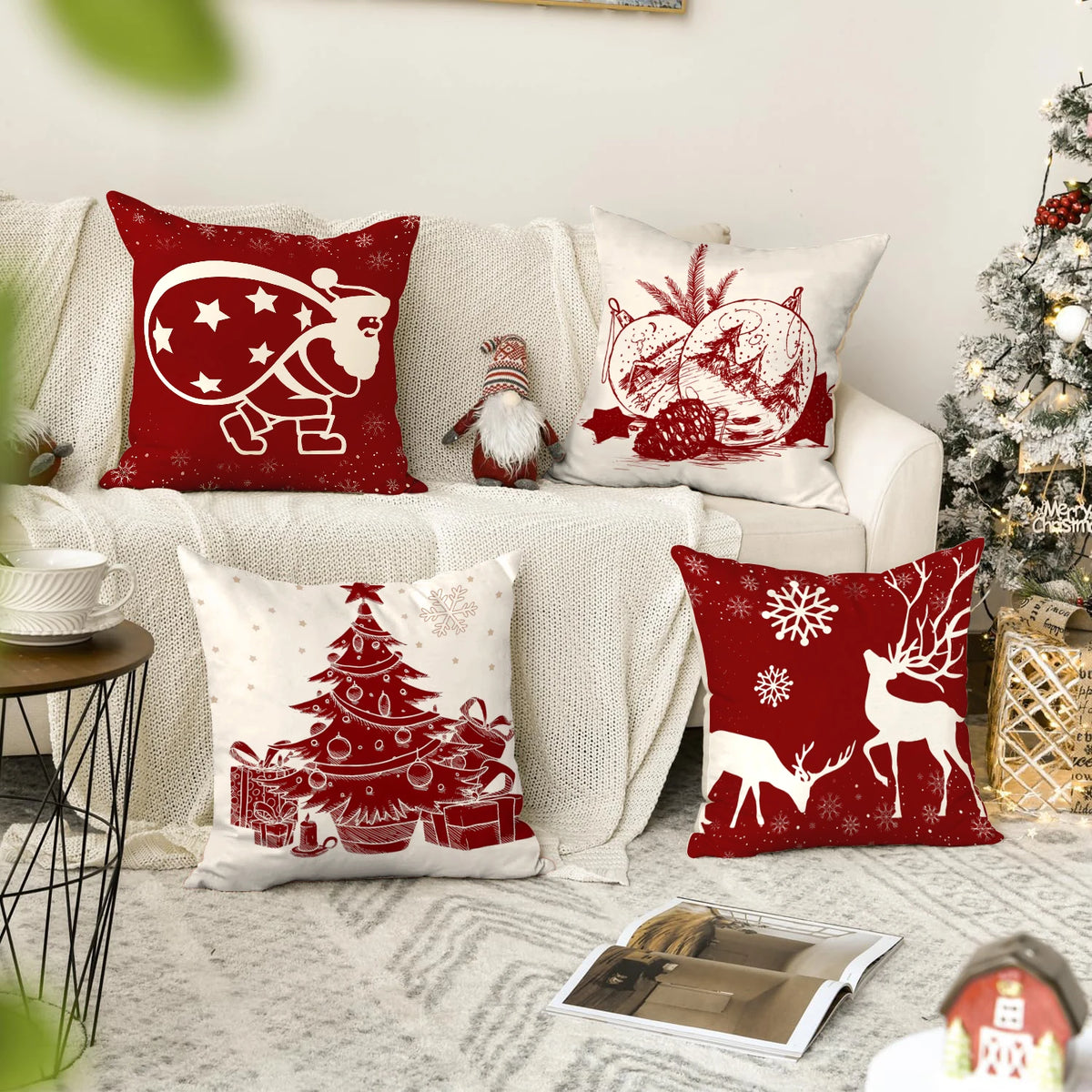A set of red and white Christmas snowflake tree pillows displayed on a light-colored sofa.