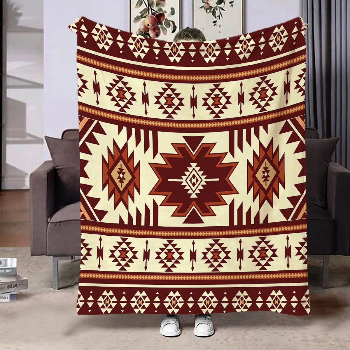A patterned flannel throw blanket featuring a geometric ethnic print in shades of brown and cream.
